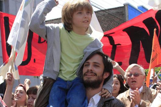photo from film No: Gael García Bernal carries boy in a protest